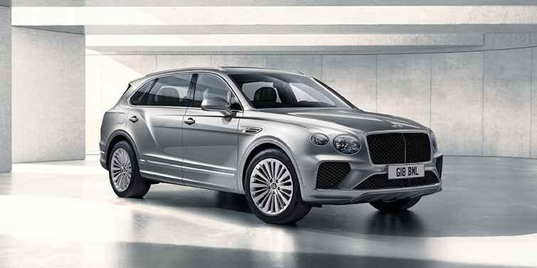 Bentley Lima Bentley Bentayga Extended Wheelbase SUV front three quarter in Moonbeam paint with a grey background
